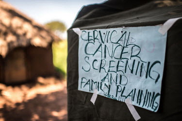 A temporary cervical cancer screening tent set up in a village during a RHU mobile clinic visit.
