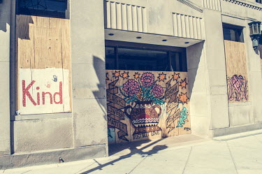 Graffiti painted on a boarded over building following protests, some violent, against the police shooting of Jacob Blake.