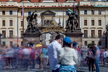 Crowds in-front of the Wrestling Titans (Sousosi Souboj Titanu), also known as Fighting Giants and Giants' Gate, which are pair of outdoor sculptures leading to the first courtyard of Prague Castle in...