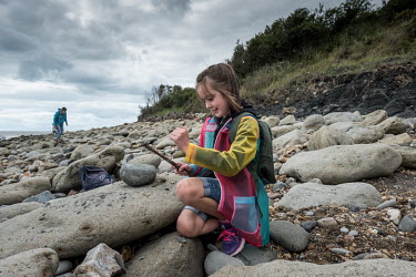 Connie Warner examines a belemnite fossil she has just discovered on a beach between Lyme Regis and Charmouth during a fossil hunting trip on the so-called Jurrassic Coast. Belmnites are the remains o...