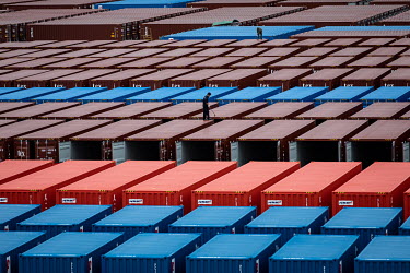 A worker inspects shipping containers in a stockyard at the Singamas Container Holdings factory. As part of their pledge to cut emissions by 70 percent by the end of 2017, and in response to the Chine...