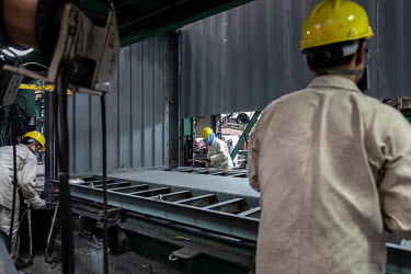 Workers assemble a shipping container in the welding shop at the Singamas Container Holdings factory. As part of their pledge to cut emissions by 70 percent by the end of 2017, and in response to the...