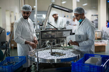 Technicians Saad El Hakkoumi and Mohammed El Oumame prepare final products in the in the conditioning and packaging unit of the MCI Sante Animale laboratory where MCI is developing a bivalent Rift Val...