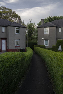 An avenue of hedges between houses in Warriston, Edinburgh.  Hedges offer increased privacy, isolating the homeowner and emphasising the division of public and private space. Where boundaries between...