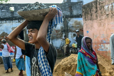 Mumtaz (12) working at a construction site along with his father in Bara village. He is working as schools have been closed due to the coronavirus lockdown.