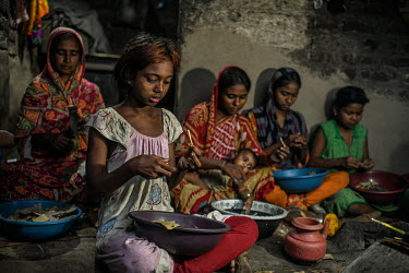 Payal Khatoon (11) (nearest camera) makes bidi (cigarettes) with her family, including her mother and grandmother, at a small house in bidi worker's colony in Aurangabad in Murshidbad district. Payal...