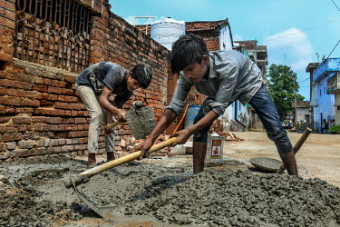Mumtaz (12) and Shahanawaz (R, 10) working at a construction site in Bara village. He is working as schools have been closed due to the coronavirus lockdown.