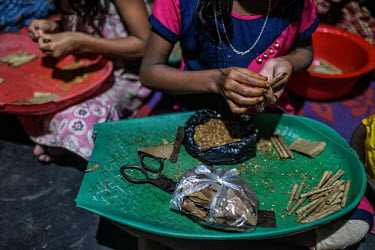 Girls make bidis at a factory house in bidi worker's colony in Aurangabad in Murshidbad district. Children are working with their family's as schools have been closed due to the coronavirus lockdown.