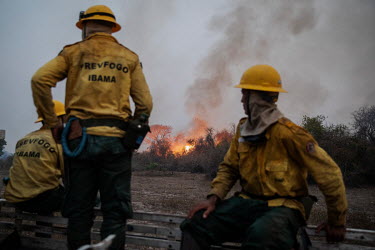 Members of the Brazilian Institute for the Environment and Renewable Natural Resources (IBAMA) fire brigade point to a spot fire as they travel to the Santa Tereza farm, in the Pantanal, where they ar...