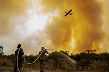 Firefighters and volunteers spray water into the undergrowth as they try to combat outbreaks of fire near the Sesc Porto Cercado hotel in the Pantanal.  Since the beginning of 2020, the Pantanal has...