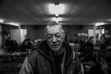Dave Tubbs (58) has lunch at a church soup kitchen.