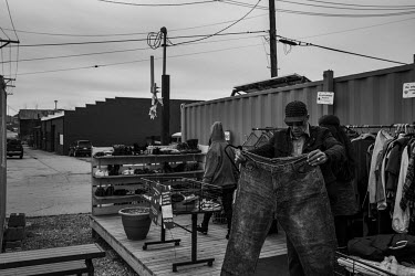 A man examines a pair of jeans at a Free Store in Braddock, a town hit hard by urban decline. The population of Pittsburgh, the urban area that Braddock is a part of, has halved since its 1960s high p...