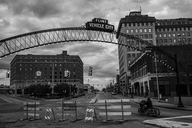 A sign welcoming drivers to Flint reads 'Flint vehicle city'.