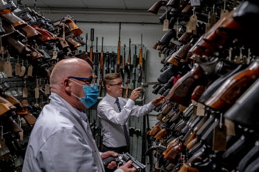 Gregg Taylor (right), with an unnamed colleague, in the gun collection room at the National Ballistics Intelligence Service.