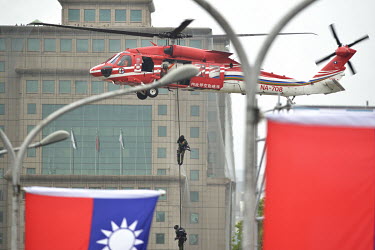 A SWAT team abseil from a helicopter during a simulation exercise during official celebrations marking the 109th Taiwan (The Republic of China) National Day on 10 October 2020.