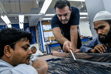 Maximiliano Modesti (centre) demonstrates a design to one of his highly skilled staff who are employed to embroider beads and sequins to fabrics in Modesti's factory in Lower Parel. Maximiliano Modest...