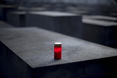 A red candle burns on one of the stelae of the Holocaust Memorial (Memorial to the Murdered Jews of Europe) during a ceremony on the 75th anniversary of the liberation of the Auschwitz death camp. Pol...