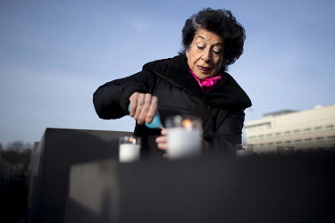 Journalist and activist Lea Rosh lights a candle during a ceremony to commemorate the victims of the Holocaust at the Holocaust Memorial (Memorial to the Murdered Jews of Europe) on the 75th anniversa...