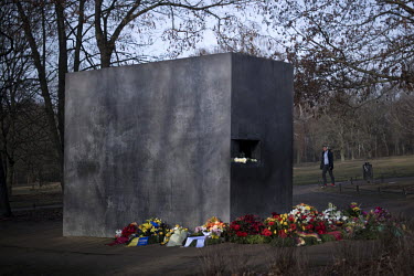 Flowers left at the base of a memorial, in the Tiergarten, to homosexual victims of the Nazis on the 75th anniversary of the liberation of the Auschwitz death camp. The memorial, a large concrete slab...