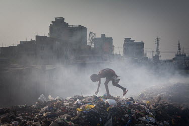 A homeless boy searches a rubbish dump for items that can be sold to recyclers.  It is estimated that there are more than 600,000 street children living in Bangladesh, 75% of them live in the nation's...