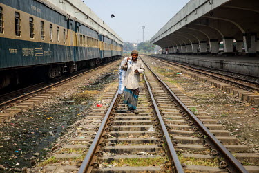A homeless boy carries a sack of recycling along a railway track.  It is estimated that there are more than 600,000 street children living in Bangladesh, 75% of them live in the nation's capital, Dhak...