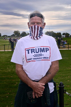 Ed Murphy (64), a retired sheet metal worker from Maryland, standing on Constitution Avenue looking up to the South Lawn of the White House as President Donald Trump (still recovering from COVID-19) d...