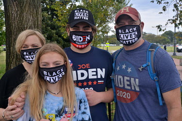 The Snyder family, Jessica, Rachel (10), Ethan (13) and father Robert, wearing various apparel indicating their support for Joe Biden and Black Lives Matter. The family were standing on Constitution A...