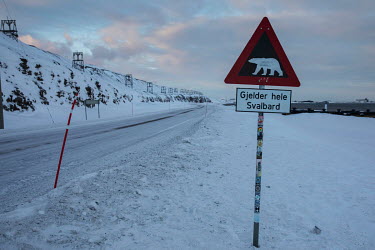 A sign indicates the possible presence of polar bears on a road in the Svalbard archipelago. Temperatures in this region are warming faster than anywhere else on the planet, rising at least 4Â�C in r...
