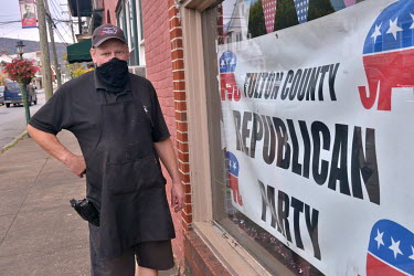 Gary Tritle (58), a butcher, stands outside his store in McConnellsburg where he is renting space to the county's Republican Party (GOP). Tritle, who has a 9mm pistol at his side, says he is a Trump s...