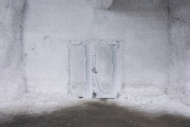 An ice-encrusted door inside the Global Seed Vault where, in recent years, the main tunnel has experienced some flooding due to permafrost melt. Temperatures in this region are warming faster than any...