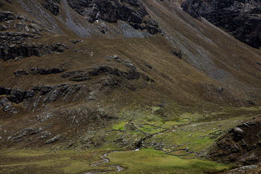 Shepherd's huts within the Huascaran National Park beneath part of the Cordillera Blanca mountain range.