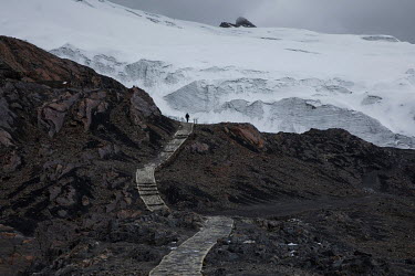 A person walks on a path that leads to the Pastoruri Glacier in the Huascaran National Park. The glacier is shrinking rapidly having lost half of its surface area since 1995.