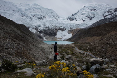 Juan Victor Morales Moreno (52) observes Lake Palcacocha in the Cordillera Blanca. His job is to watch the lagoon 24 hours a day and report by radio any disturbance to the Regional Operations and Emer...