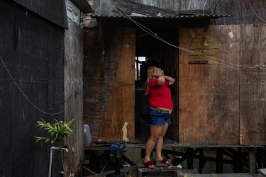 Dyennifer Silva in front of her home in the Mangue Seco favela. The improvised settlement has been the subject of studies on adaptation to climate change.