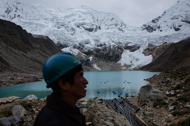 Juan Victor Morales Moreno (52) looks down at pipes that drain Lake Palcacocha in the Cordillera Blanca. His job is to watch the lagoon 24 hours a day and report by radio any disturbance to the Region...