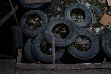 Second hand truck tires used to protect the foundations of a stilt house from high tides in the Mangue Seco slum.