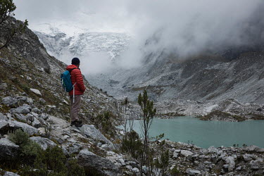 Farmer and mountain guide Saul Luciano Lliuya stands above the Llaca Laggon which is fed by the rapidly retreating Llaca glacier in the Cordillera Blanca mountain range. Saul is suing a German energy...