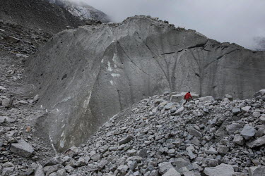 Farmer and mountain guide Saul Luciano Lliuya walks over moraine from the rapidly retreating Llaca glacier which feeds the nearby Llaca Laggon in the Cordillera Blanca mountain range. Saul is suing a...