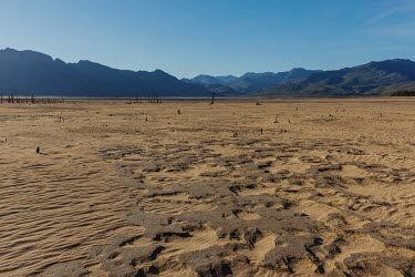 The dry bed of the Theewaterskloof reservoir, which supplies much of the water for the city of Cape Town. In early 2018, when the dam's water was predicted to decline to critically low levels, the cit...