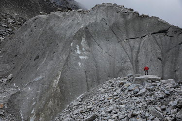 Farmer and mountain guide Saul Luciano Lliuya walks over moraine left by the rapidly retreating Llaca glacier which feeds the nearby Llaca Laggon in the Cordillera Blanca mountain range. Saul is suing...
