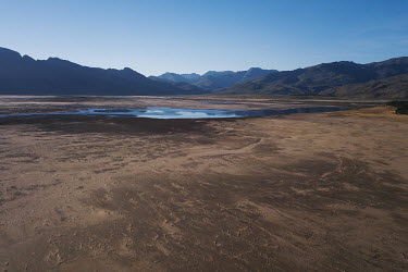 The dry bed of the Theewaterskloof reservoir, which supplies much of the water for the city of Cape Town. In early 2018, when the dam's water was predicted to decline to critically low levels, the cit...