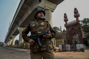 Security personal on guard outside a mosque in the Maujpur area. When rival groups, largely split between Hindus and Muslims, began protesting for and against the new Citizenship Amendment Act, violen...