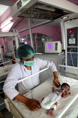A health worker treats a premature baby who is undergoing treatment in the Phototherapy Ward at the Virangna Avanti Bai District Women's Hospital.