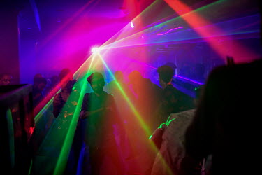 Lasers light people dancing at disco in Hotel No 18 at Fort Kochi.