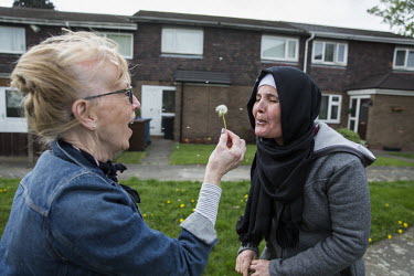 Colette Pritchard shows Noura Daour (44) how to make a dandelion clock.  The Daour family, originally from Syria, have been supported in their resettlement by the UK Community Sponsorship scheme which...