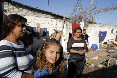 Women and children outside a breeze block house in a gypsy neighbourhood.