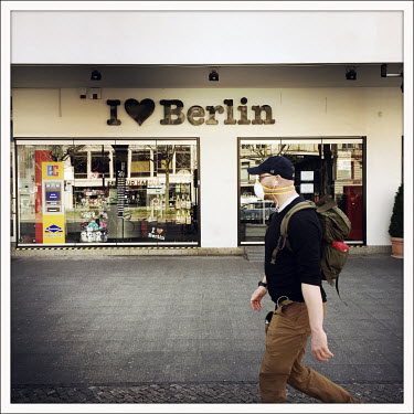 A man passes the closed 'I Love Berlin' shop on the Kurfuerstendamm.  The Berliner Ku'damm is lined with luxury boutiques, hotels and restaurants. The coronavirus has resulted in deserted pavements an...