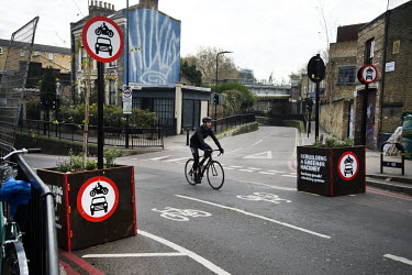 A bicyclist passes through the entrance to a no-car zone on Middleton Road in Hackney.