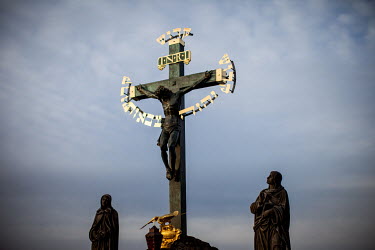Sculptures and a cross at Charles Bridge in Prague.