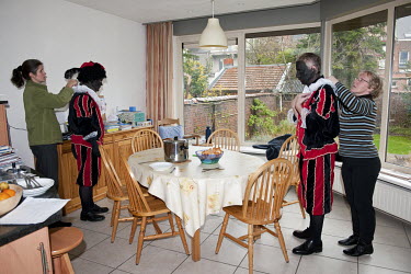 White men put on costumes and blackface as they dress up as Swartz Piet characters to perform with Saint Nicholas or Sinterklaas (Santa Claus) and give out presents to children.
